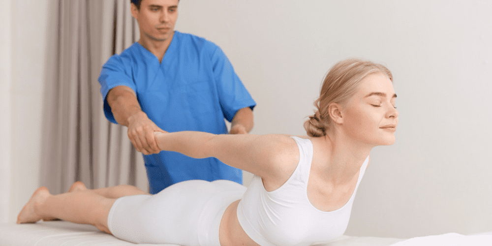 A women having a Chiropractor help her with her back to improve flexibility