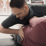 A man getting his back adjusted by a chiropractor.